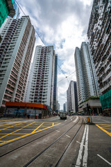 Fototapeta na wymiar Road and high buildings in Quarry Bay in Hong Kong. Rail tracks on the ground.