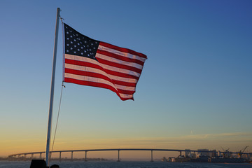 American flag of the United States of America  floating in the sky on a mast in San Diego,...