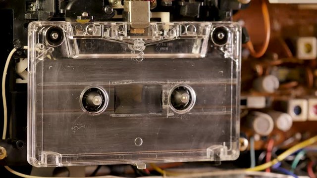 Cassette Tape playing in open tape recorder