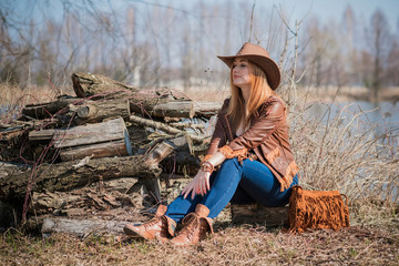 American style, girl in Leather cowboy jacket and hat, with nice modern figure and full hips 