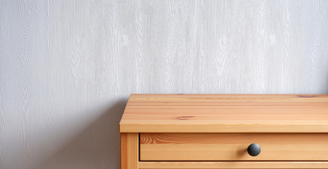Beautiful design of a wooden table, against a blue wall. Advertising background.