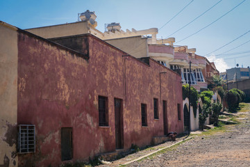 Fototapeta na wymiar Asmara, Eritrea - November 01, 2019: Old Buildings and Cars around of Local Market