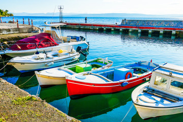 Colorful fishing boats docked at the harbour in Greece