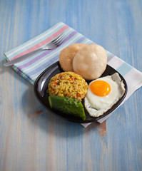 Asian fried rice homemade nasi goreng dish served with prawn crackers krupuk and sunny side up egg