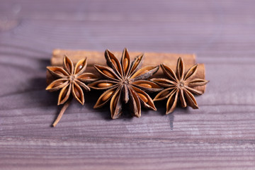 star anise and cinnamon on brown wooden background