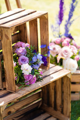 Decorative element from wooden boxes and fresh flowers. Details Party Decoration