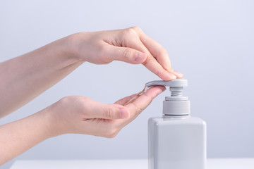 Hand washing. Asian young woman using soap to wash hands, concept of hygiene to stop spreading coronavirus isolated on gray white background, close up.