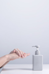 Hand washing. Asian young woman using soap to wash hands, concept of hygiene to stop spreading coronavirus isolated on gray white background, close up.