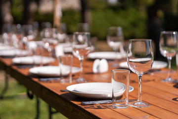 Served wooden table without a tablecloth. Cafe in the open air park