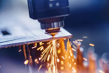 Gordijnen CNC laser machine cutting sheet metal with light spark. Technology plasma industrial, Blue steel color © Parilov