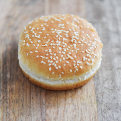 wheat bun with sesame seeds on a wooden table hamburger ingredients