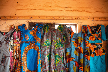 Colorful African Womens Clothing handing on the wall of a shop 
