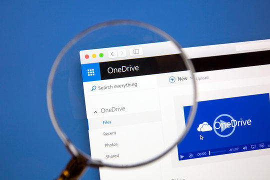 Ostersund, Sweden - Aug 14, 2016: Microsoft OneDrive website under a magnifying glass. Microsoft OneDrive is a file hosting service.