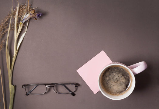 Cup of coffee and a note on the desktop,copy space