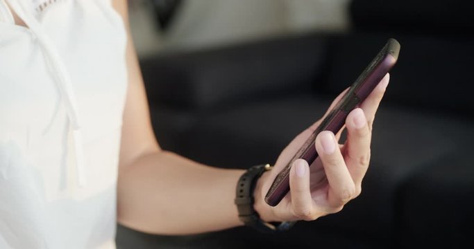 Close-up of woman hand using wet wipe and sanitizer to clean cell phone screen. People cleaning and disinfecting mobile telephone monitor to kill virus and germs. Female hands holding smartphone