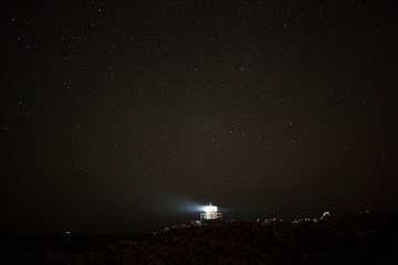 Fototapeta premium Swedish lighthouse in snow on a windy winter night.