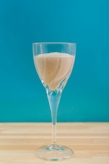 Two glasses with a banana smoothie of chocolate and ice cream on a blue background.