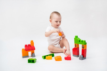 On white background with copy space. The little kid plays the constructor. game,education
