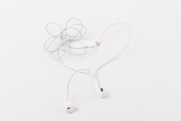 White headphones for listening to music and sound on portable devices: music player, smartphone, laptop and jack for connection on a white background.