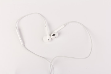 White headphones for listening to music and sound on portable devices: music player, smartphone, laptop and jack for connection on a white background.