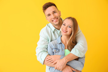 Fototapeta premium Happy young couple on color background