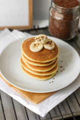 Pancakes with a beautiful serving. Pancakes tower on a white plate.  Delicious breakfast