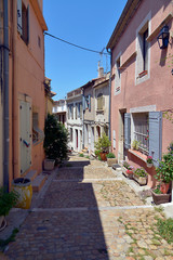 Typical street of the old city center of Arles,  a city and commune in the south of France