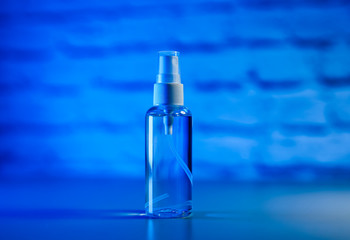 Bottle of antiseptic, a bottle of hand sanitizer. Hand sanitizer spray on a blue background .Prevention coronavirus, a copy space. COVID-19 and coronavirus identification. Pandemic