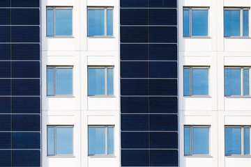 White building with Solar panels installed on the outer walls.