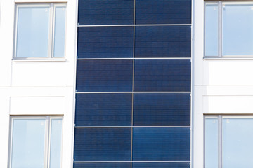 Fototapeta premium White building with Solar panels installed on the outer walls.