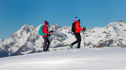 Fototapeta na wymiar Two female climbers during a training walk on the snow