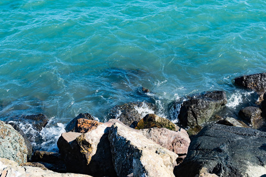 Beach Stones and green ocean water back ground image