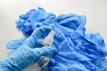 Fototapeta premium Disposable latex gloves in blue. Antiseptic in a transparent flocon.
