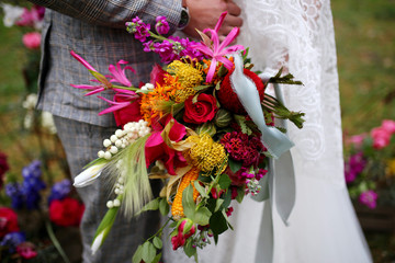 beautiful wedding bouquet with red, pink and white flowers, roses and eucalyptus, peonies, calla lilies.