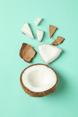 Flat lay with coconut on mint background, top view