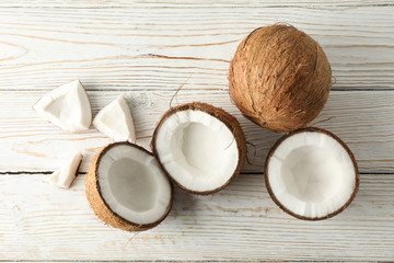 Coconut on wooden background, top view. Tropical fruit