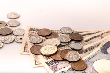Japanese coins and banknotes and passport on white table