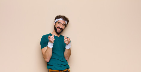 young sports man expressing a concept against flat wall