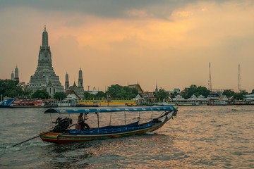 traditional thai boat at sunset