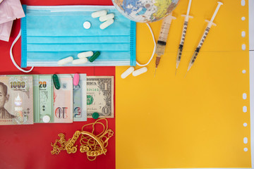 Banknote on red background near mask, pill capsules  and syringe Concept medicine for life.