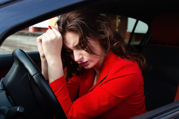 Stressful beautiful girl in the car