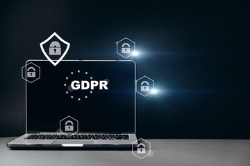 Front view of blank screen laptop, sign general data protection regulation GDPR and shield with key icon on grey background with copy space. Cyber internet security concept.