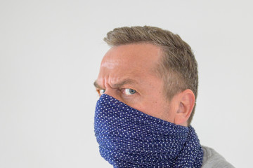 Paranoid man wearing a face guard against Covid-19