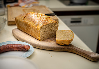 homemade healthy whole grain bread that has just been taken out of the oven and placed on the kitchen counter.