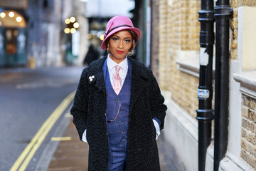 a portrait of a young woman dressed in a tweed suit