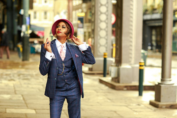 a young woman dressed in a tweed suit smoking