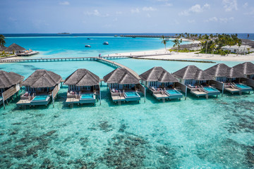 Perfect aerial landscape, luxury tropical resort or hotel with water villas and beautiful beach...