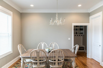 Informal kitchen dining room with a large window, natural light and hardwood floors perfect for family dinners
