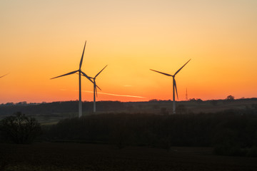 Fototapeta na wymiar Wind turbines stationary at sunset