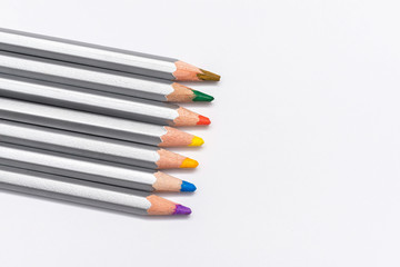 Naklejka premium gray wooden pencils with colored rods on a white background